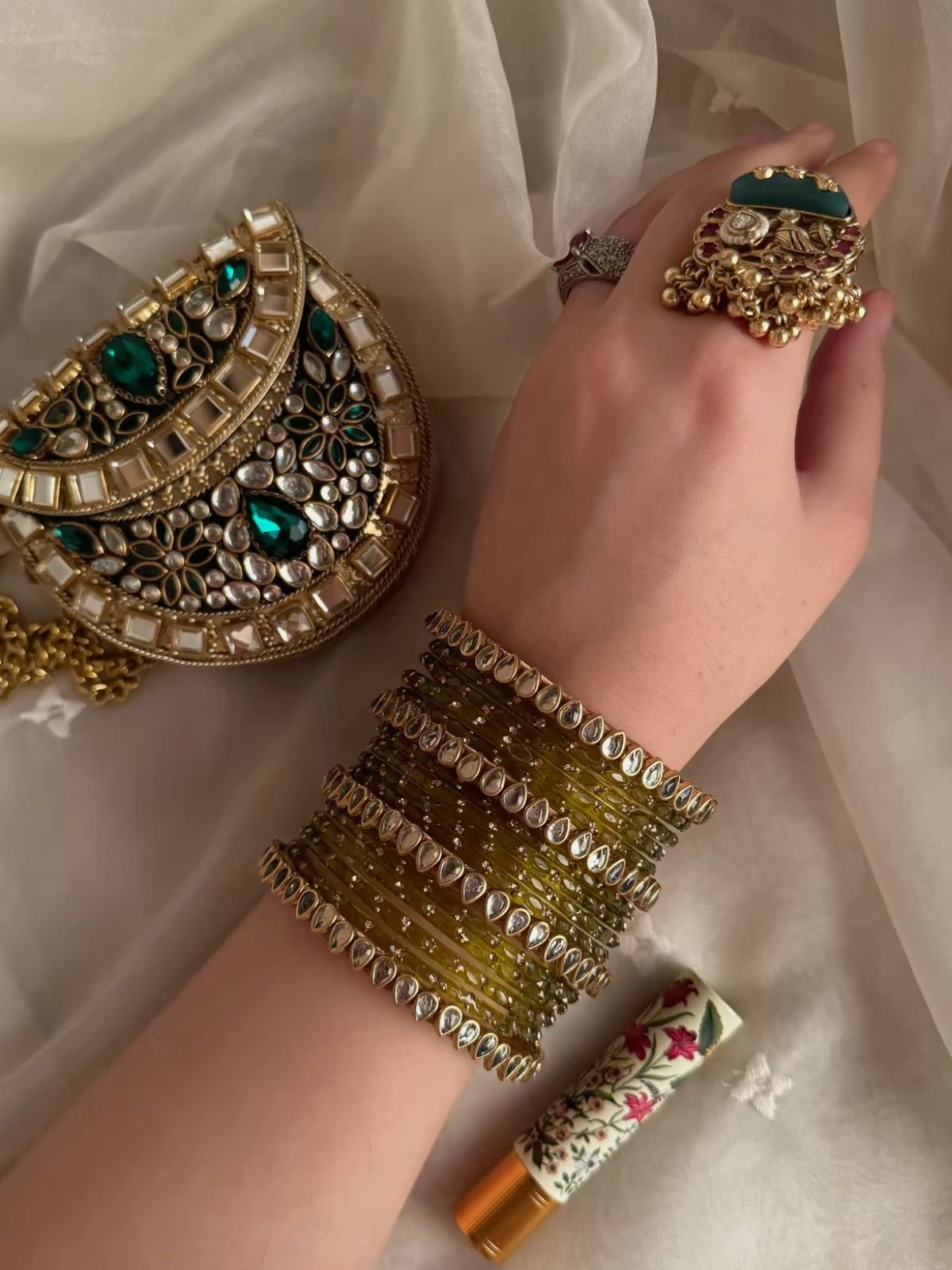 Elegant model wearing an ivory and gold embroidered lehenga with delicate jewellery